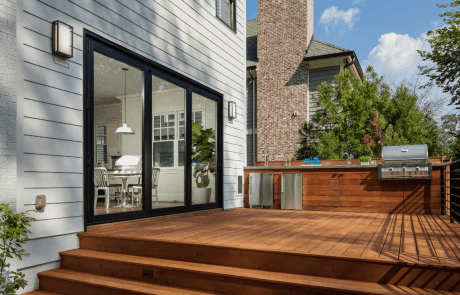 renovated porch with silver grill and kitchen