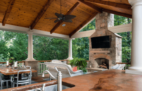 outdoor patio with fireplace and kitchen