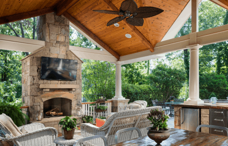 outdoor patio with fireplace and kitchen