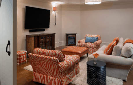 living room with orange themed sofas