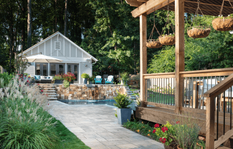 Outdoor living redesign includes a custom pool and backyard renovation in Atlanta with a natural paver walkway and terraced patio using Belgard’s Lafitt Rustic Slabs