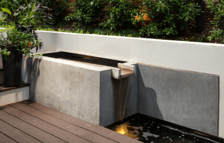 modern custom concrete water feature on the lower deck is a gorgeous focal point for the space and creates a Zen atmosphere