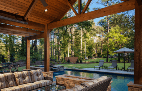 Custom, backyard renovation incudes a rectangular swimming pool with 2 tanning ledges, a raised spa with spillover