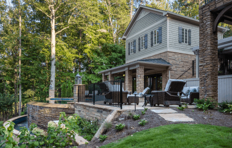 Luxurious backyard retreat with 2-story custom-built pool house and garage, infinity edge pool, and knife edge spa.