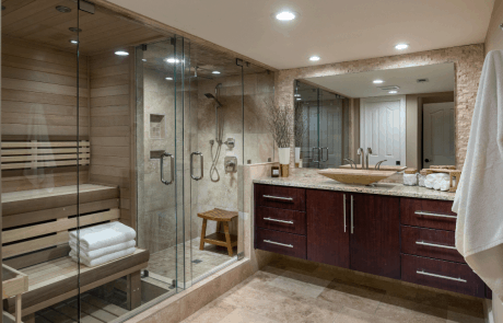 This beautiful custom spa like bathroom remodel features a glass surround shower with niche, a private sauna, floating vanity with granite countertops, vessel sink and quarter sawn walnut cabinets and Travertine stone floors.