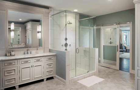 master bath with his and hers custom-built beaded inset vanities painted Agreeable Grey with Calacatta Gold marble countertops and glass-mounted sconce lighting