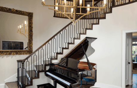 curved grand staircase with iron balusters in a dramatic alternating oval and square pattern