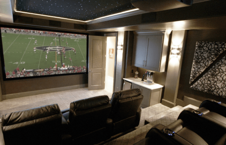 This custom basement renovation includes a state-of-the-art home theater with stadium seating, custom acoustic panels, a fiber optic star ceiling, home concession stand and a custom designed automated lighting system. The 12-foot screen and high performing surround sound system provides the ultimate movie experience.