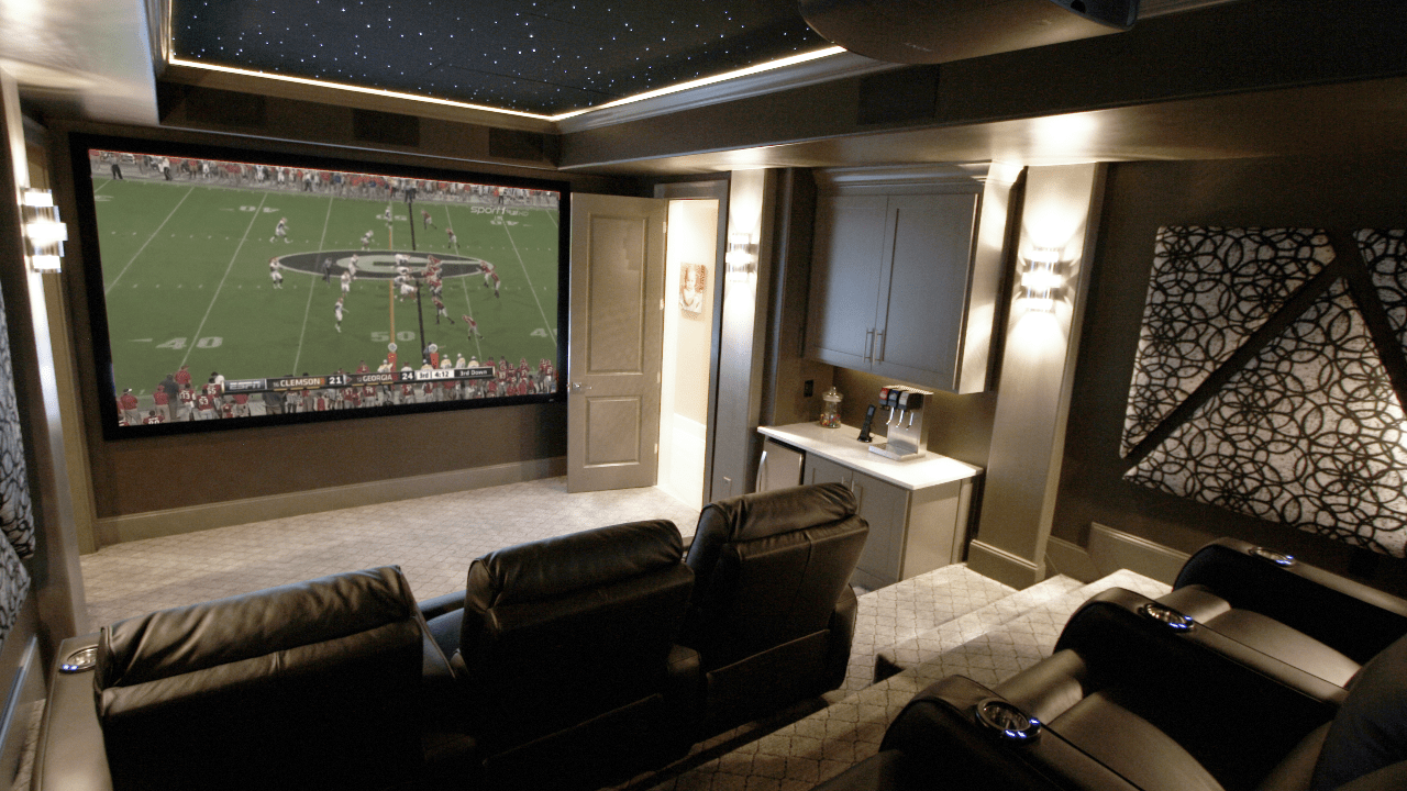 This custom basement renovation includes a state-of-the-art home theater with stadium seating, custom acoustic panels, a fiber optic star ceiling, home concession stand and a custom designed automated lighting system. The 12-foot screen and high performing surround sound system provides the ultimate movie experience.