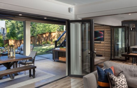 Black Panoramic Doors open the entire width of the basement and create an instant Indoor/Outdoor connection for entertaining.