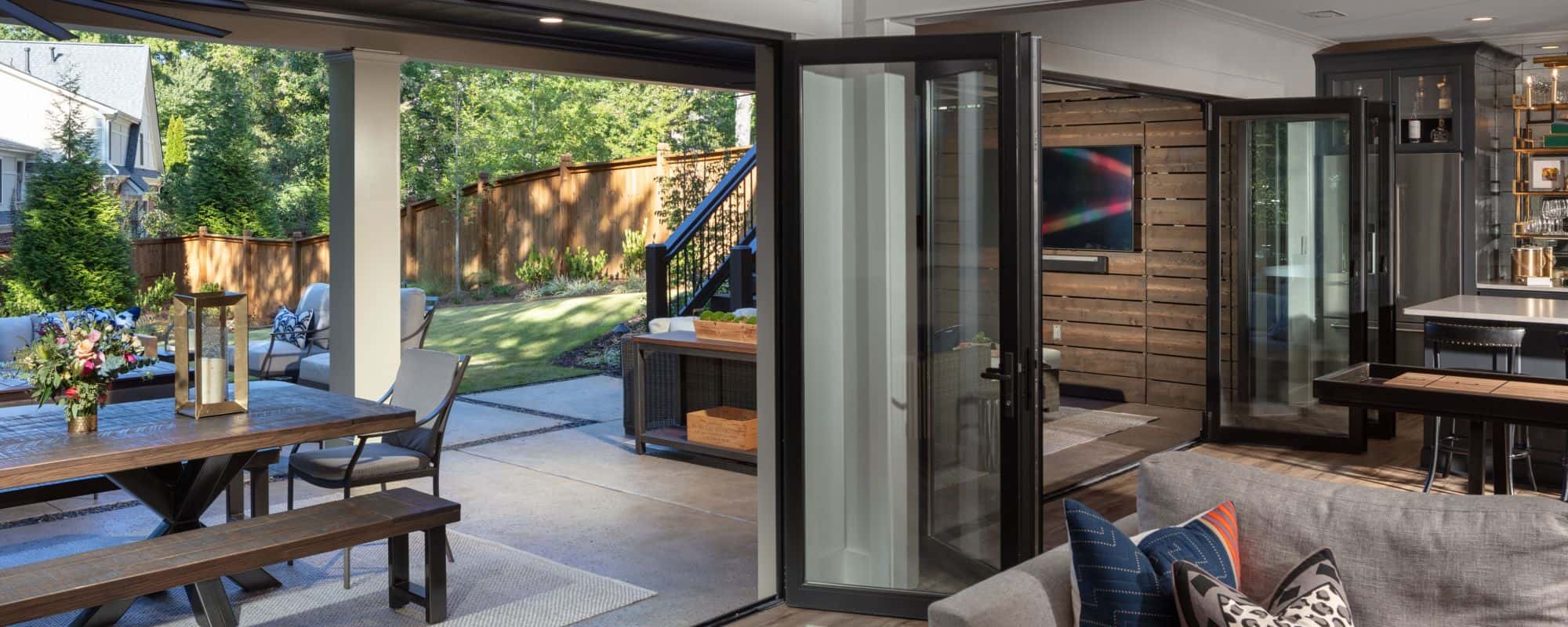 Black Panoramic Doors open the entire width of the basement and create an instant Indoor/Outdoor connection for entertaining.