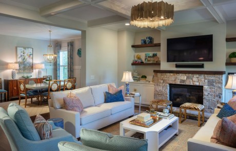 Transitional, blue and white, open concept family room and dining room with stone fireplace and mounted tv, custom built ins, coffered ceilings, designer décor and contemporary lighting.