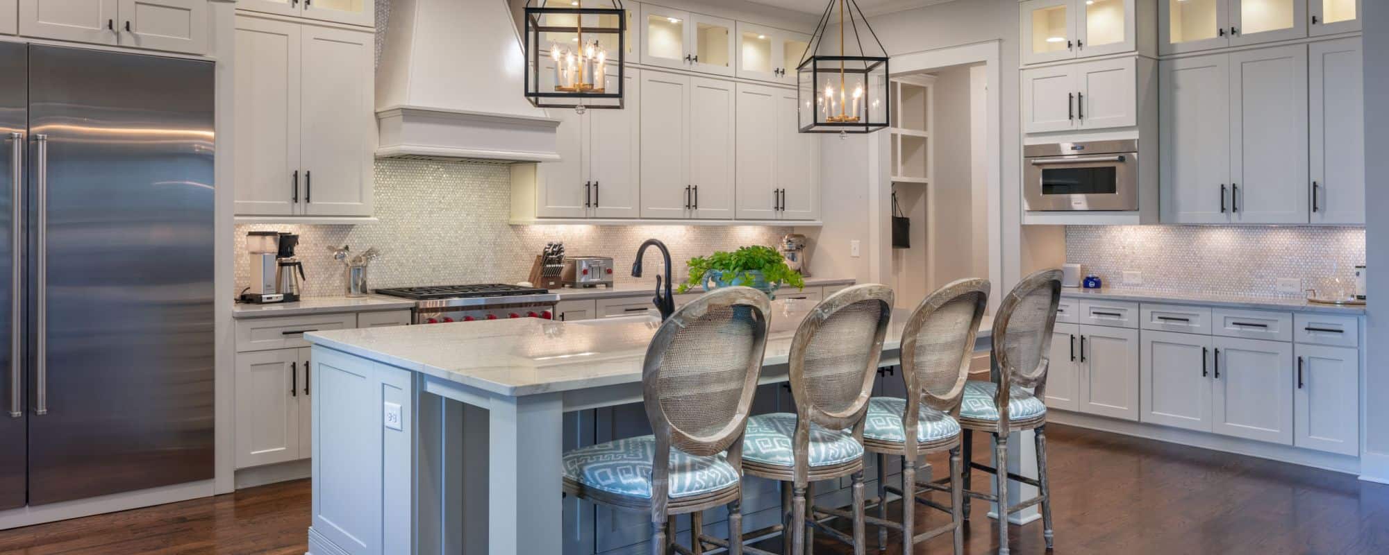 large kitchen with white marble tops