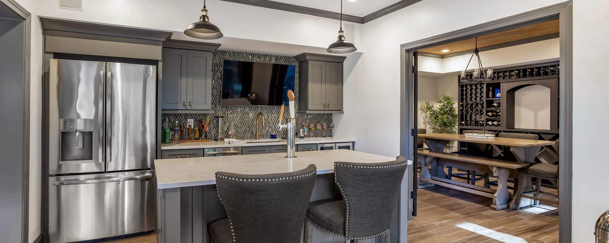 remodeled kitchen with white marble counter tops and grey chairs