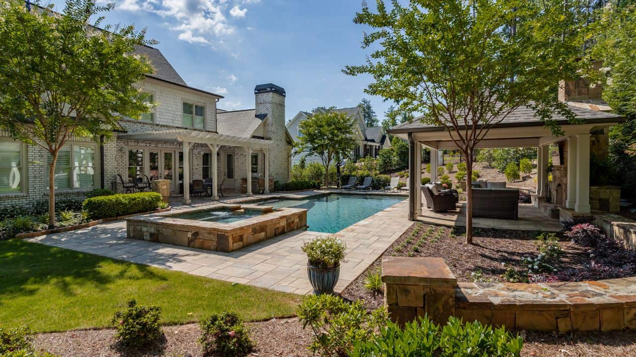 large backyard with pool and jacuzzi