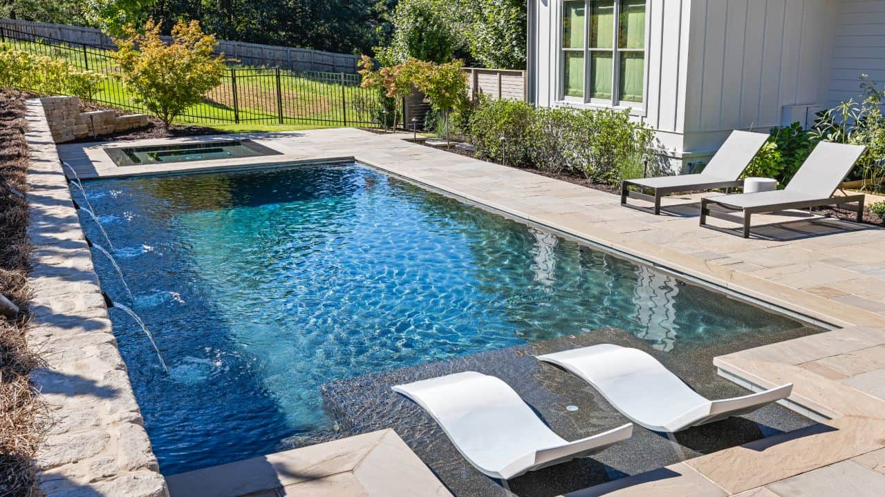 Luxury swimming pool installation & outdoor pool entertainment area with knife edge perimeter overflow spa.