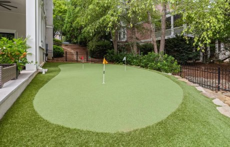 Ray-20-Gallery Custom designed backyard putting green beside covered patio and infinity-edge pool.