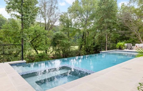 Ray-27-Gallery Elevated infinity-edge pool with matching spa creates a seamless visual connection to nature blending modern design, tranquility, and craftsmanship by Boyce Design + Build.